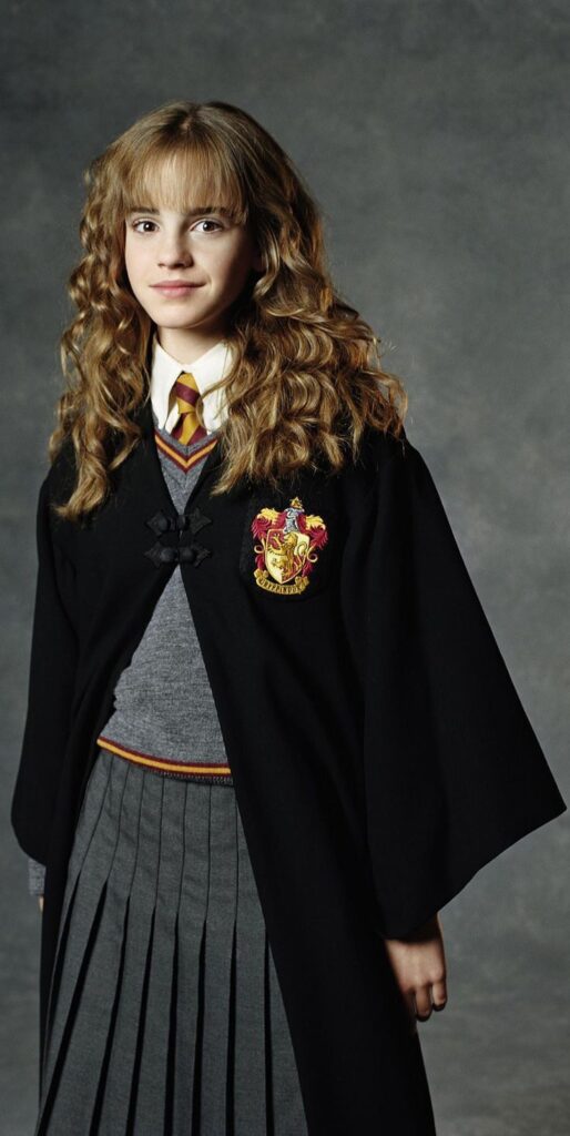 Hermione Granger standing in Gryffindor uniform